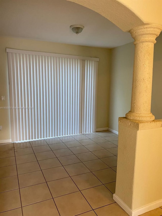 1519 SE 24th Ct Unit 238, Homestead, FL 33035 - tiled empty room featuring decorative columns and baseboards