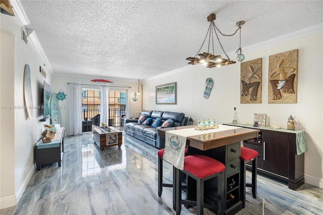 dining room featuring light wood-type flooring, ornamental molding, and a textured ceiling