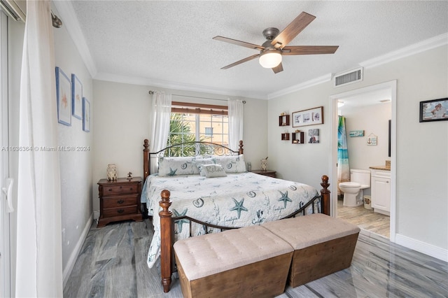 bedroom with connected bathroom, ceiling fan, crown molding, light hardwood / wood-style floors, and a textured ceiling