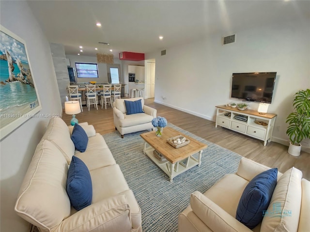 living room with light hardwood / wood-style flooring