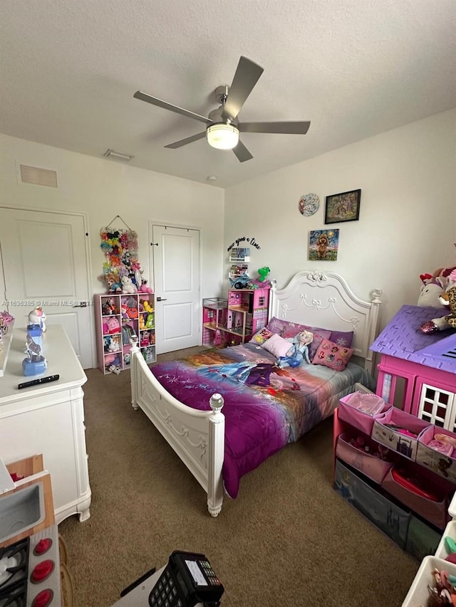 bedroom featuring ceiling fan and carpet