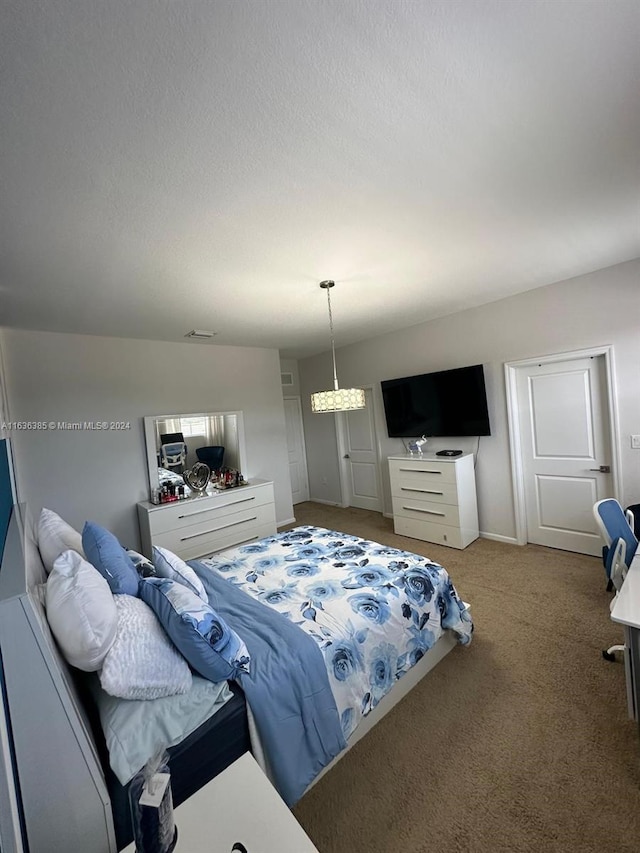 bedroom with carpet floors and a textured ceiling