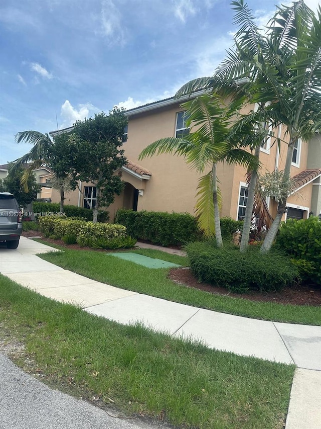 view of side of home with a lawn