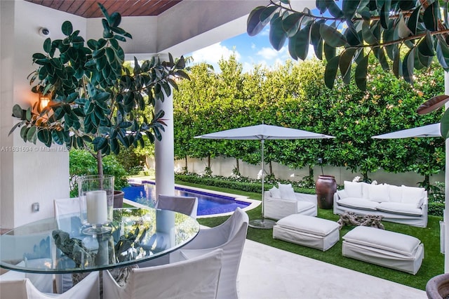 view of patio / terrace featuring outdoor dining space, outdoor lounge area, a fenced backyard, and a fenced in pool