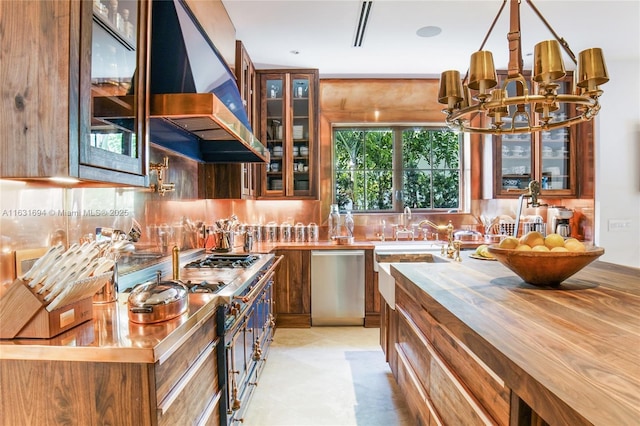 kitchen featuring range hood, backsplash, brown cabinets, dishwasher, and glass insert cabinets