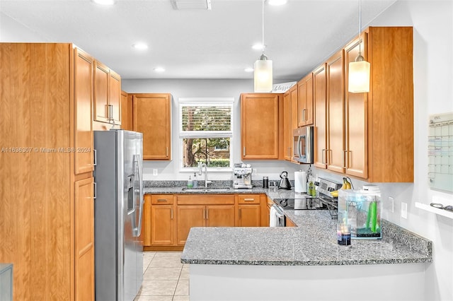 kitchen featuring stone countertops, kitchen peninsula, stainless steel appliances, sink, and light tile patterned flooring