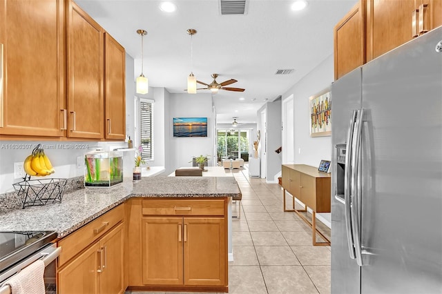 kitchen featuring kitchen peninsula, stainless steel appliances, light stone countertops, light tile patterned floors, and ceiling fan