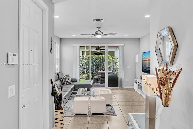 tiled living room with ceiling fan