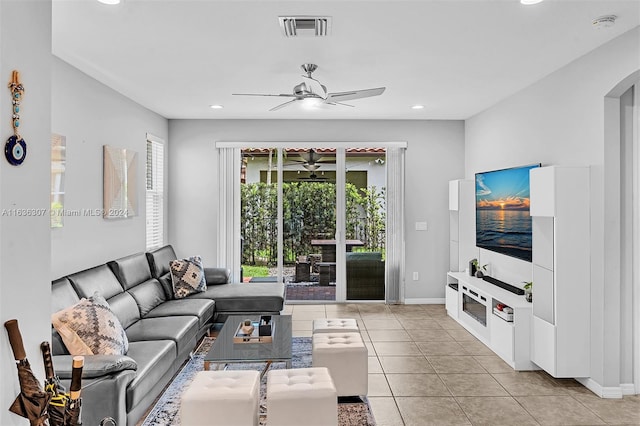 tiled living room featuring ceiling fan