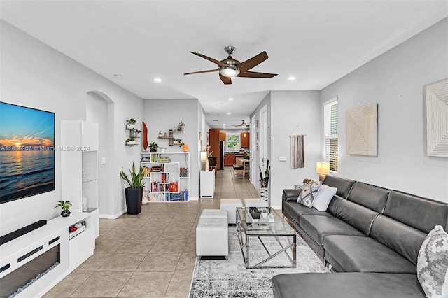 living room featuring ceiling fan and light tile patterned floors