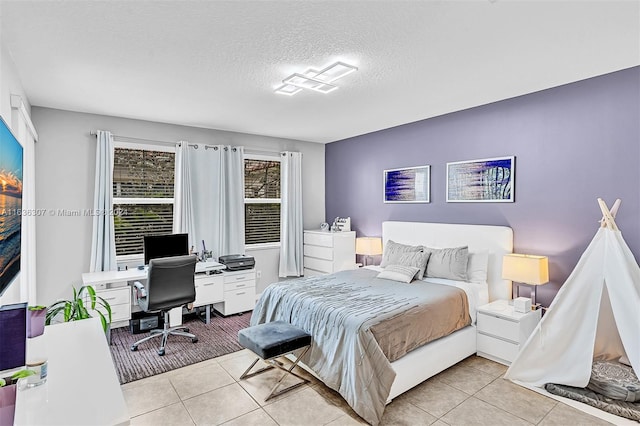 bedroom with light tile patterned flooring and a textured ceiling