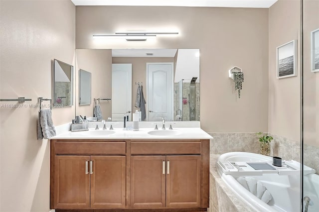 bathroom featuring vanity and shower with separate bathtub