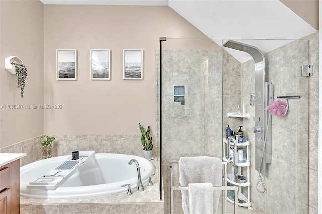 bathroom featuring vanity, lofted ceiling, and separate shower and tub