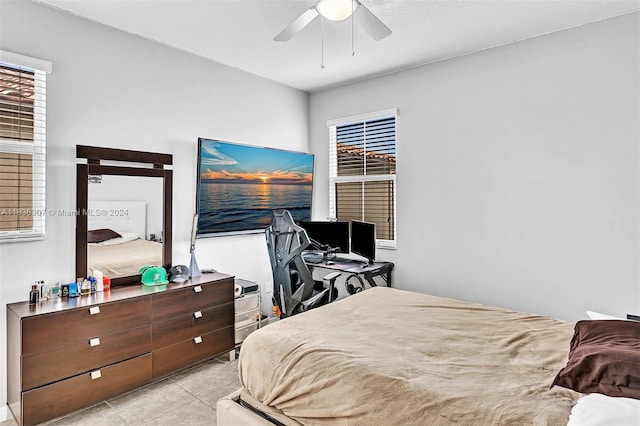 bedroom featuring light tile patterned floors and ceiling fan