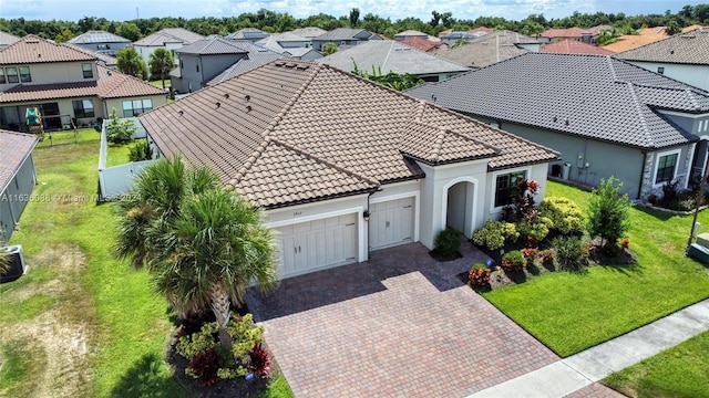 view of front of property featuring a garage and a front lawn