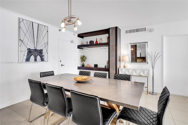 tiled dining space with a notable chandelier