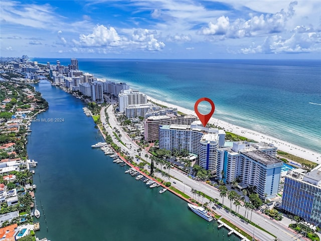 birds eye view of property featuring a water view and a view of the beach