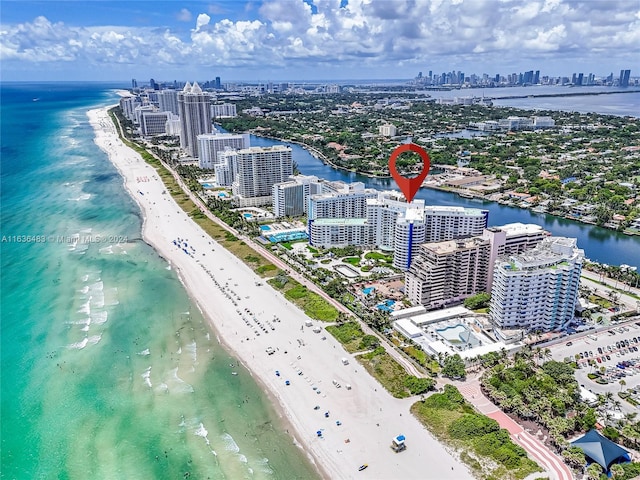 drone / aerial view with a beach view and a water view