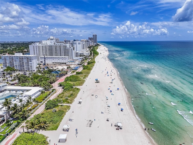 aerial view with a water view and a beach view