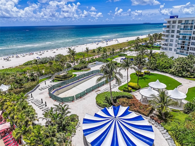 drone / aerial view with a water view and a beach view