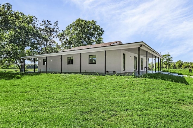 rear view of house with a lawn