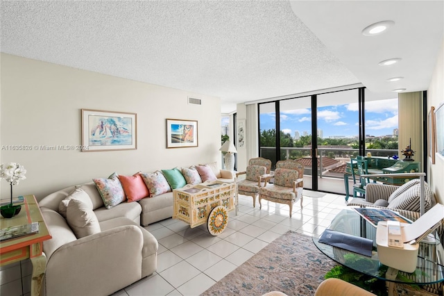 living room featuring floor to ceiling windows, light tile patterned floors, and a textured ceiling