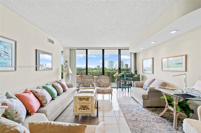 tiled living room with expansive windows and a textured ceiling