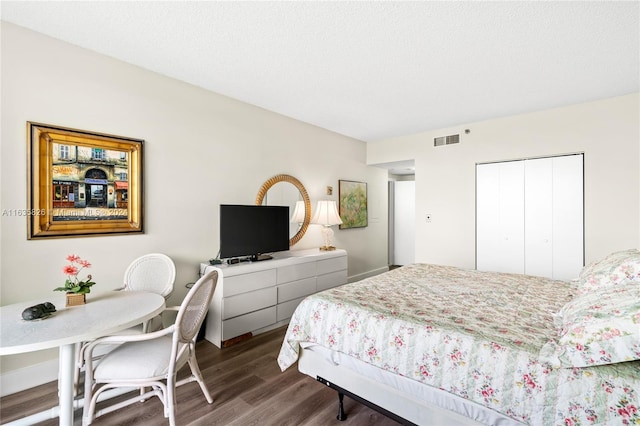 bedroom featuring hardwood / wood-style floors and a closet