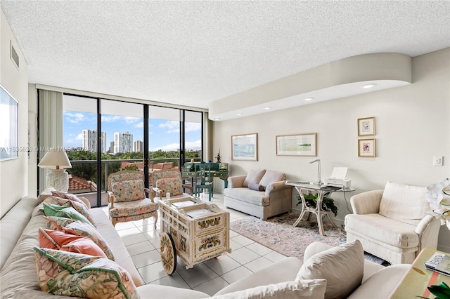 tiled living room with a textured ceiling, a wall of windows, and plenty of natural light