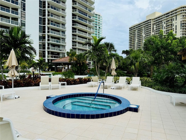 view of swimming pool with a community hot tub