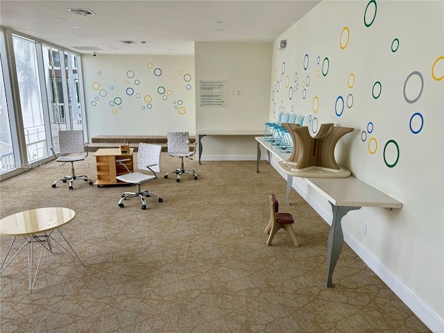 miscellaneous room featuring light colored carpet