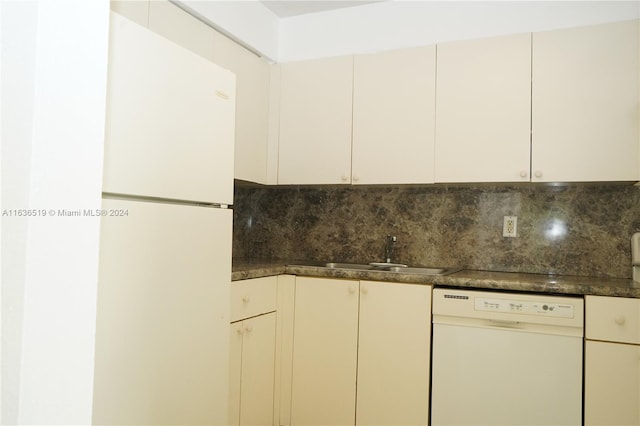 kitchen with decorative backsplash, white appliances, and sink