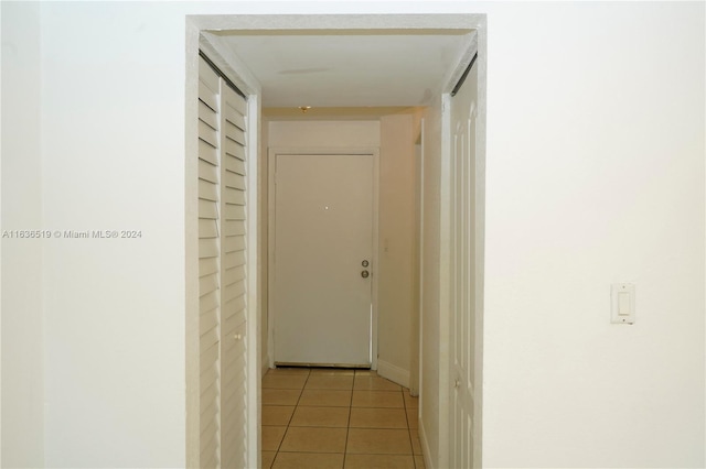 corridor with light tile patterned floors