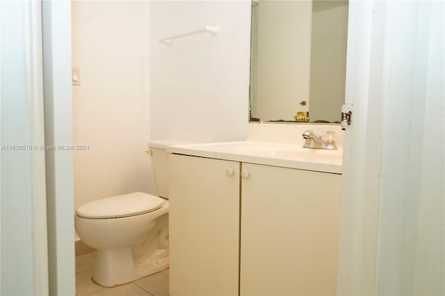 bathroom featuring vanity, toilet, and tile patterned flooring