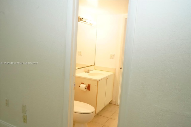 bathroom featuring tile patterned flooring, toilet, and vanity