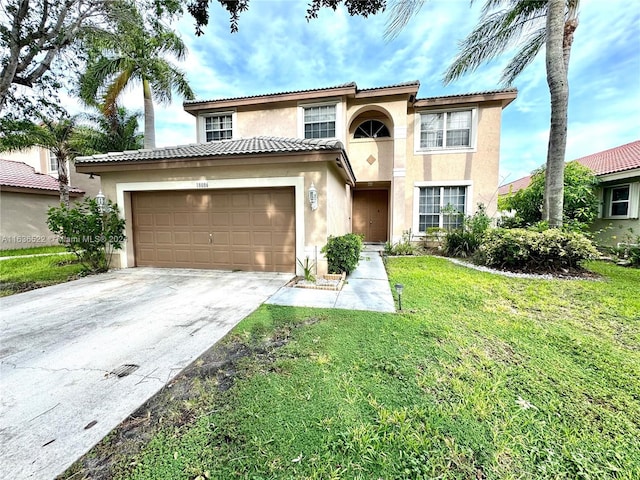 mediterranean / spanish-style home with an attached garage, driveway, a tiled roof, stucco siding, and a front yard