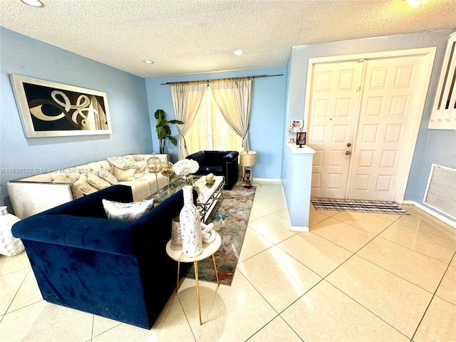 tiled living room featuring recessed lighting, visible vents, a textured ceiling, and baseboards