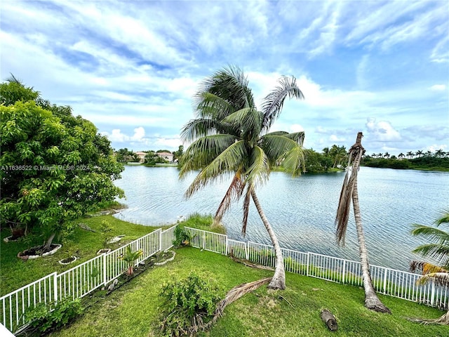 property view of water featuring fence