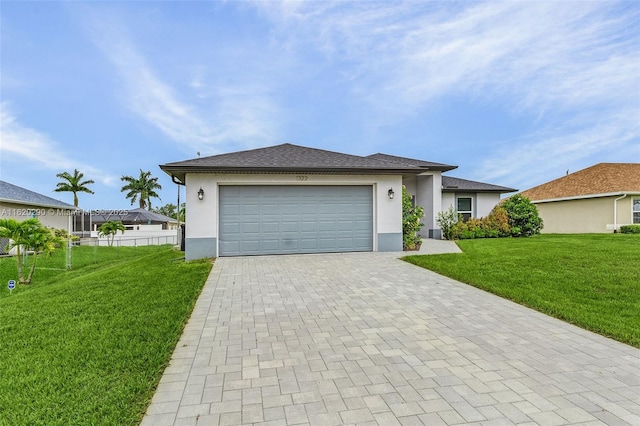 view of front of house featuring a front yard and a garage