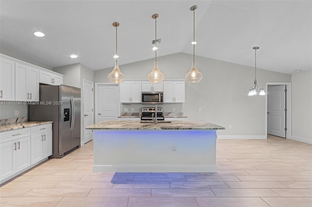 kitchen with a center island with sink, decorative light fixtures, white cabinetry, and appliances with stainless steel finishes