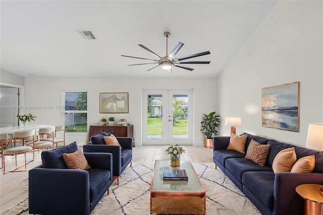 living room featuring ceiling fan and french doors