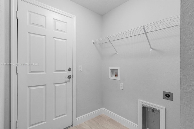 washroom featuring hookup for a washing machine, hardwood / wood-style floors, and hookup for an electric dryer