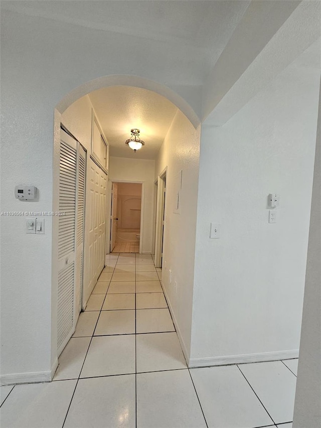 corridor with light tile patterned floors