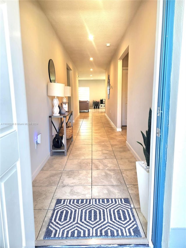 corridor with light tile patterned floors