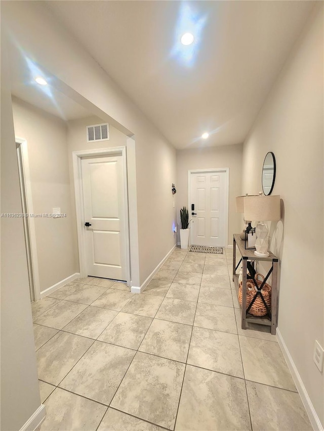 corridor featuring light tile patterned floors