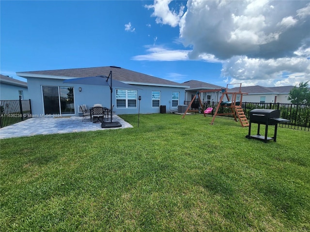 back of house with a yard, a patio, cooling unit, and a playground