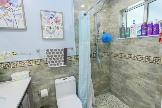 bathroom featuring a shower with shower curtain, toilet, tile walls, and vanity