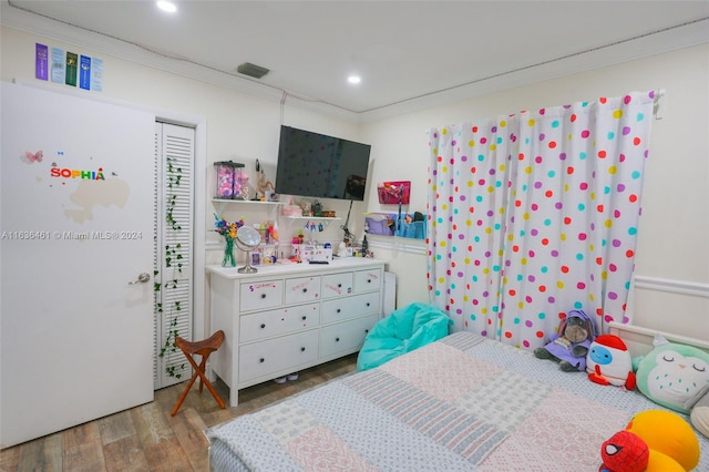 bedroom with light wood-type flooring and ornamental molding