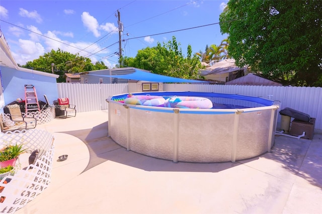 view of pool with a patio area, a fenced backyard, and a fenced in pool