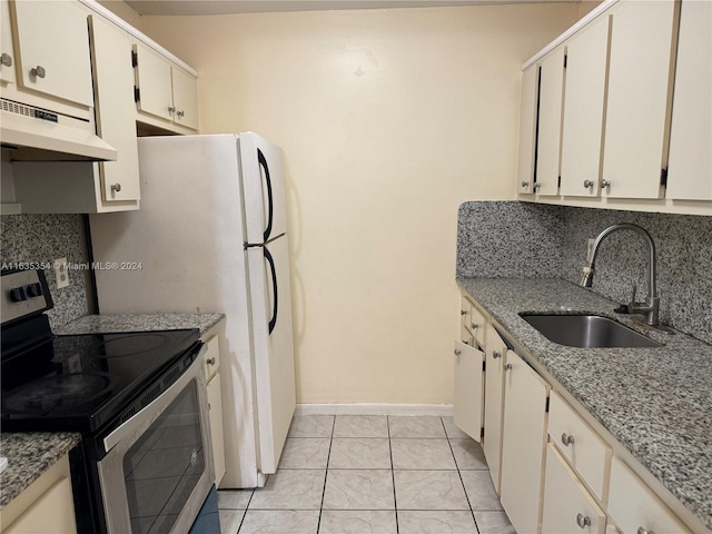 kitchen featuring decorative backsplash, light tile patterned flooring, stainless steel electric range oven, and sink